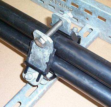 Locate the other half of the cable cleat. Secure with a nut and washer (not supplied) to the support structure and tighten the Ellis Atlas cable cleat.