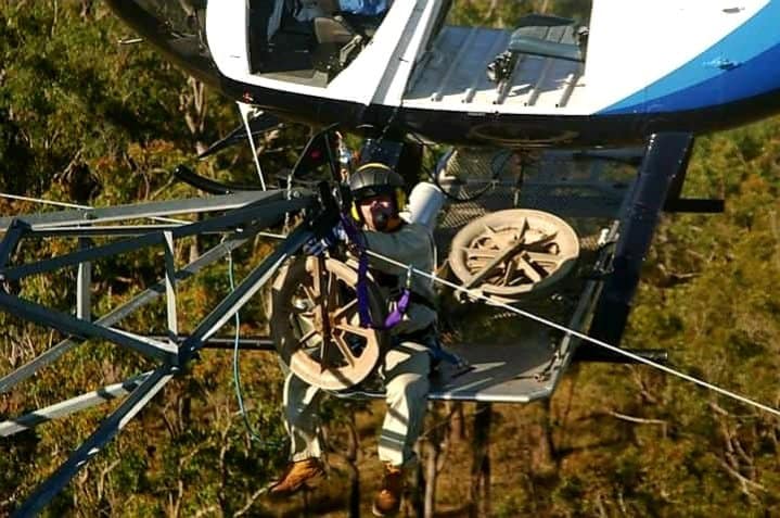 Hanging 600mm rollers to tension string OPGW using the existing earth wire as the draw wire