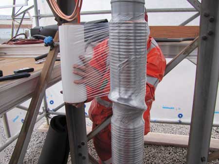 Once all the tubing is applied, thermocouple probes are placed at the middle and both outside points of the freeze to monitor temperature, and a moisture barrier is applied