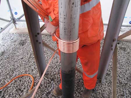 With the pipe exposed the jointer starts wrapping the the copper tube