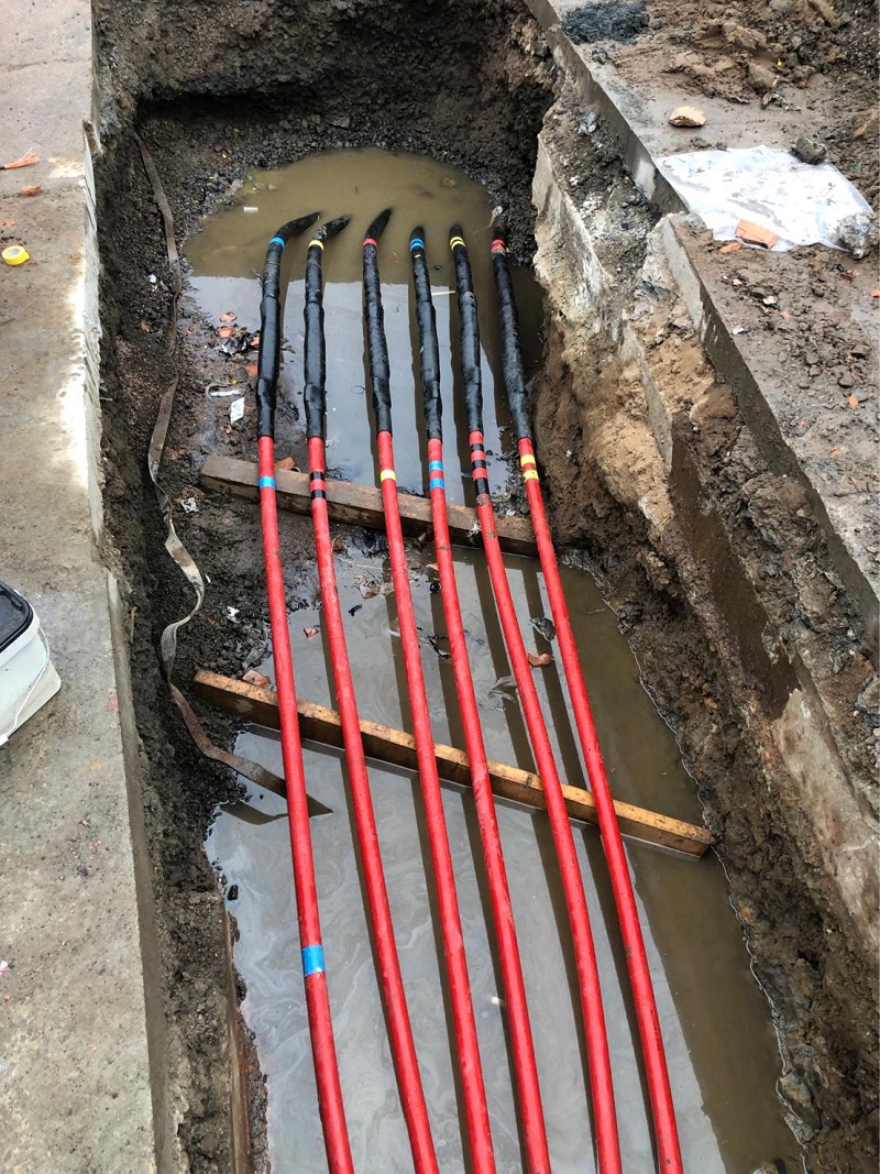 Outer adhesive heat shrink sleeves are positioned and fitted to provide moisture and mechanical protection. PILC to XLPE single core 12kV cable joint 8
