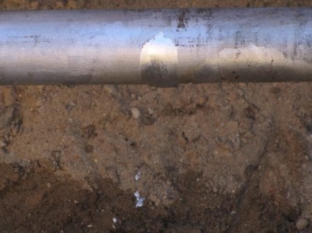 17. The EHV cable repair is complete - after this the jointer must solder a copper lead connected to a sacrificial "anode" that erodes before the cable.
