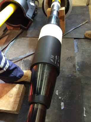 Prysmian 110kV Screen Break Joint - landing the stress control joint mould onto 1600sqmm cable. An extraction tool is used to remove the pre-mould from the carrier tube