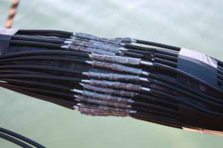 13. The submarine cable armour wires are then individually crimped together using Burndy crimping tools and then wrapped in mastic and tape.