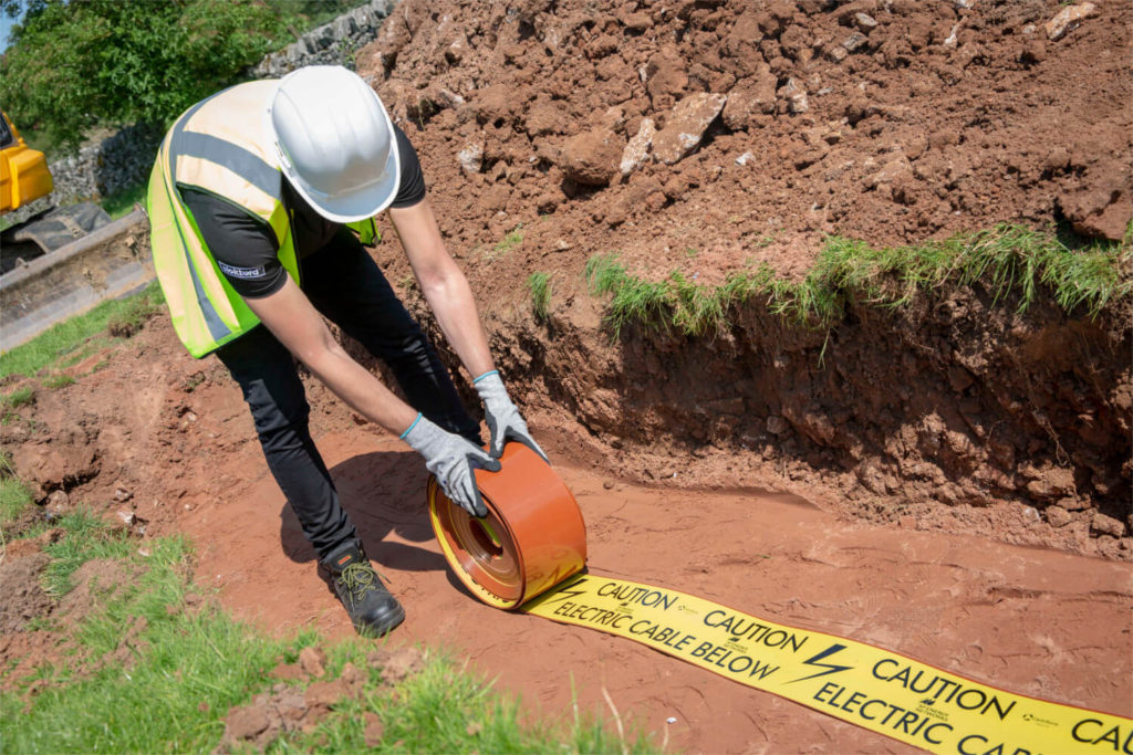 Tapetile cable warning tape manufactured by Centriforce is rolled out into the cable trench for quick and easy protection of low voltage, high voltage, street lighting and underground electricity cables up to 11kV.