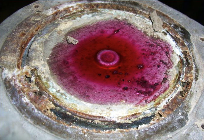 Using red dye penetrating fluid to locate a crack or leaky diaphragm.