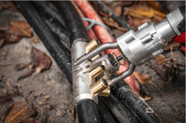 Milwaukee M18 tool used on-site for cable installation in a trench